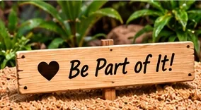 A wooden sign in the sand reading Be Part of It